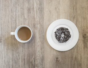 Chocolate Donut and cup of coffee on wooden background