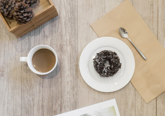 Chocolate Donut and cup of coffee on wooden background