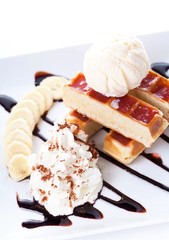 Belgian waffles with ice cream and whipped cream, Strawberry sauce and bananas