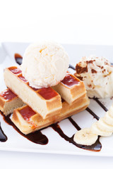 Belgian waffles with ice cream and whipped cream, Strawberry sauce and bananas