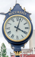 Fototapeta na wymiar Outdoor city clock near University from Bucharest.