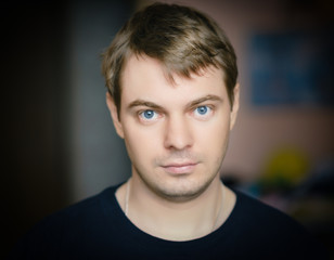 Naklejka premium Portrait of a sad man with blue eyes. Color toned image.