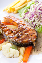 Salmon Steak with French fries and vegetables