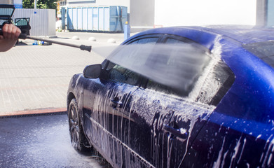 Car wash with flowing water and foam.