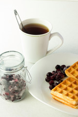 Wafers, frozen currant and tea for breakfast