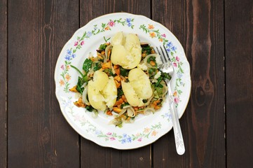 Boiled potatoes with fried chanterelle mushrooms and chard in co
