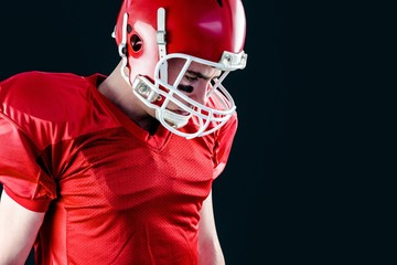 American football player taking his helmet on her head 