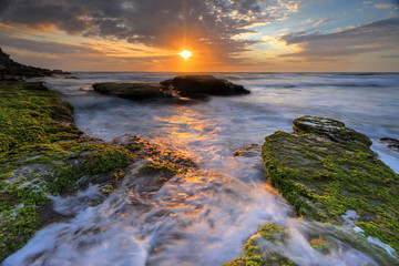 Ocean flows around the rocks at Bungan Beach