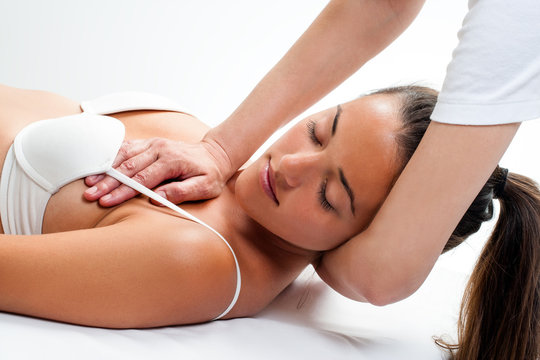 Woman having osteopathic neck massage.
