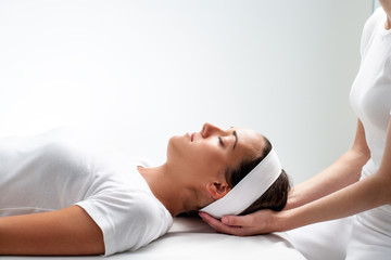 Woman relaxing at reiki session.