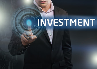 Businessman presses button investment on virtual screens. Busine