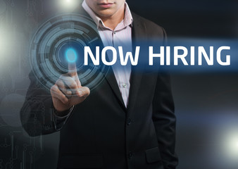 Businessman presses button now hiring on virtual screens. Busine