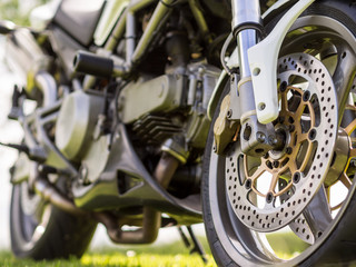 Front wheel details of a motorcycle - Powered by Adobe