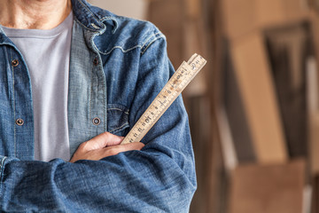 Carpenter holding a ruler