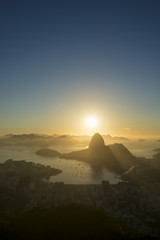 Scenic Rio de Janeiro Brazil golden sunrise over Guanabara Bay with a skyline silhouette of Sugarloaf Mountain