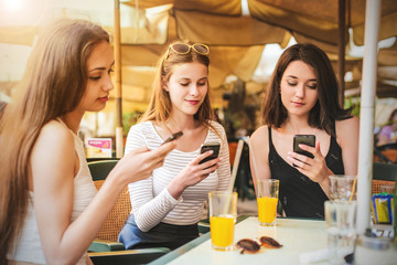 Girls chatting on their smart phones