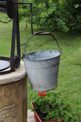 Fototapeta premium Bucket at the well / Bucket of a water well