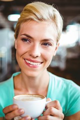 Pretty blonde holding cup of coffee