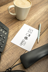 High angle view of phone, coffee, pen and notepad