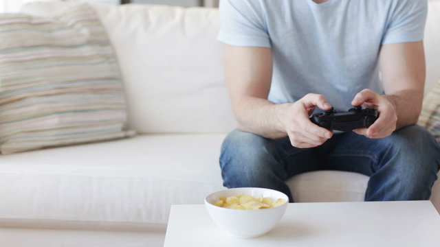 close up of man playing video game at home