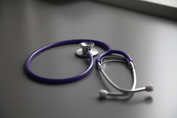 Stethoscope on the grey desk, close up