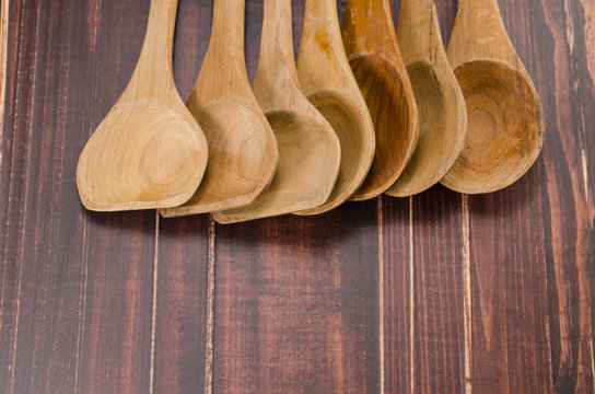 set of wooden spoon on wooden background,ladle