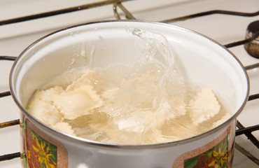 the dumplings cooks in a pan with the boiling water