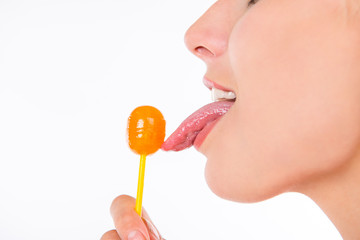 closeup photo of girl licking a lollipop