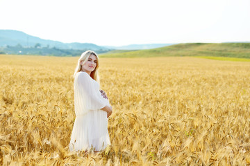 pregnant woman  in wheat field