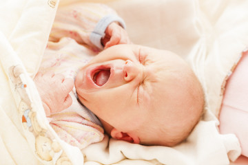 portrait of crying newborn baby girl