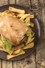 Veggie burger with salad, tomato and fries.Top view