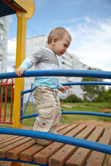 Fototapeta premium Little boy playing on a playground