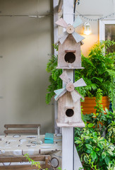 wooden bird house hanging with human house