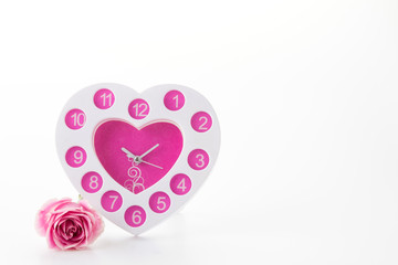white and pink clock with white and pink rose on white backgroun