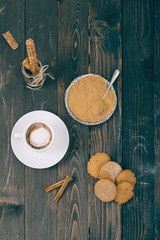Coffee and cookies on the wooden table.