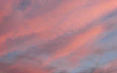 Bright pink cloudy sky before sunset for background