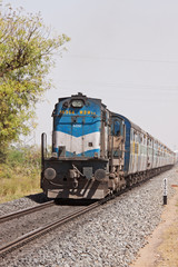 Fototapeta premium The Kolkata to Ahmedabad express passing through Rajasthan near the city of Pali