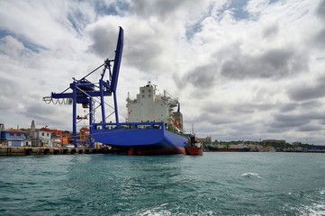 Container ship mired in industrial port