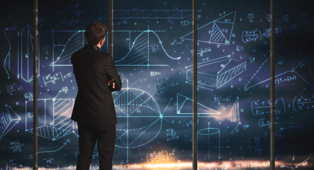 Businessman drawing business graphs