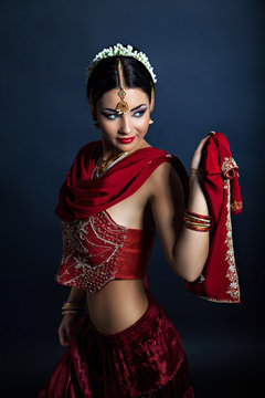 Beautiful dancing woman in traditional indian clothing