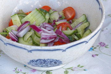 Sallad in a white and blue bowl