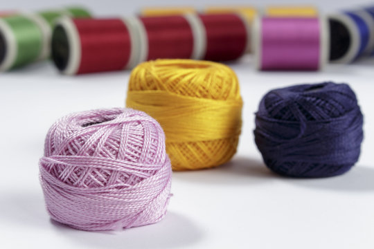 Skein of pink cotton thread in foreground