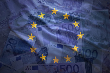colorful waving european union flag on a euro money background © luzitanija