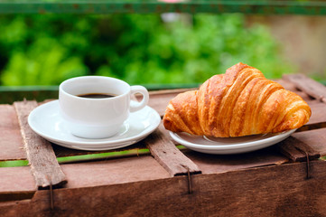 cup of coffee with croissant