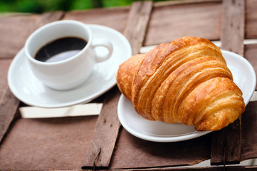cup of coffee with croissant