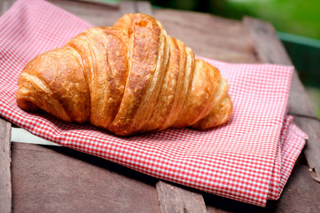 croissant on brown wood table