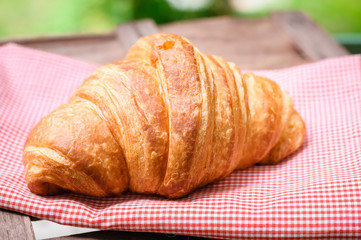 croissant on brown wood table