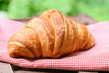 croissant on brown wood table
