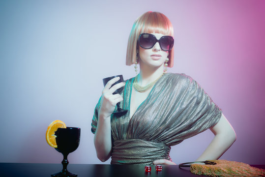 Woman in Sunglasses at Bar Holding Wine Glass