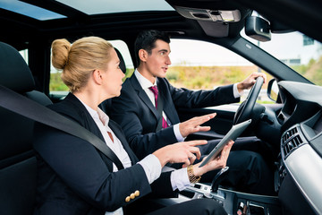 Couple in car being lost navigating with map